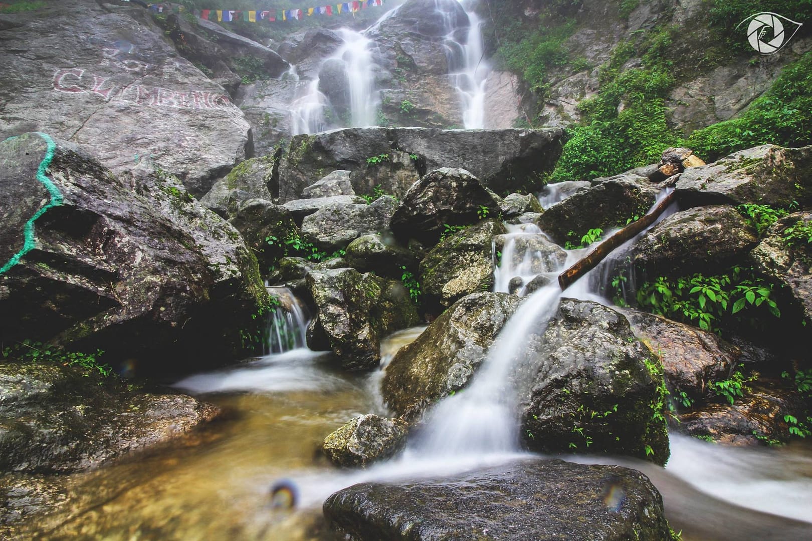 Image of a beautiful waterfall flowing gracefully among rocks and greenery.