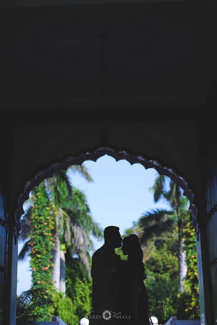 Groom kisses bride's forehead in a pre-wedding shoot.